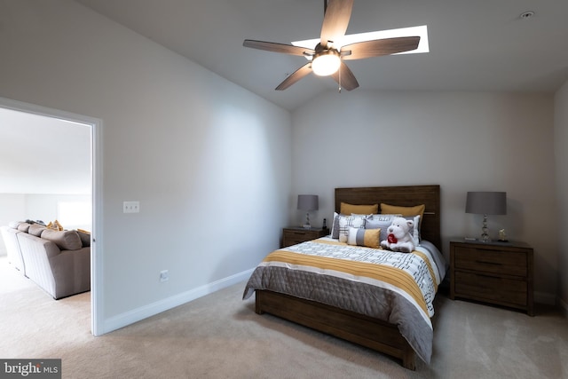 bedroom featuring lofted ceiling, light colored carpet, and ceiling fan