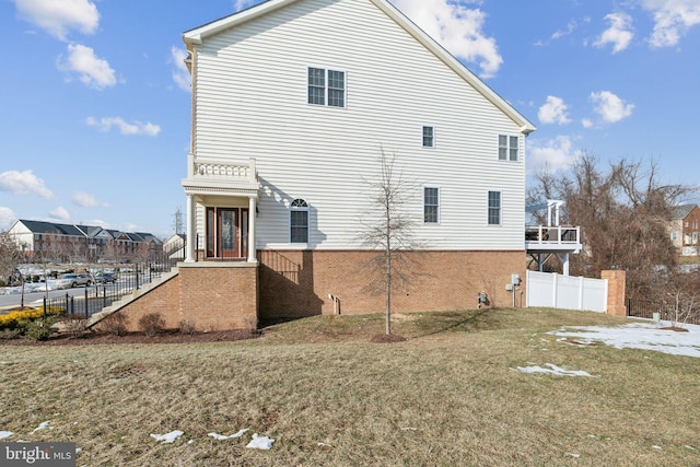 rear view of house featuring a lawn