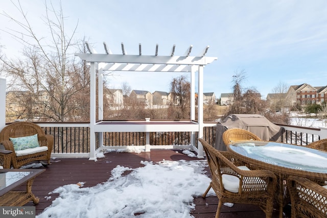 snow covered deck featuring a pergola