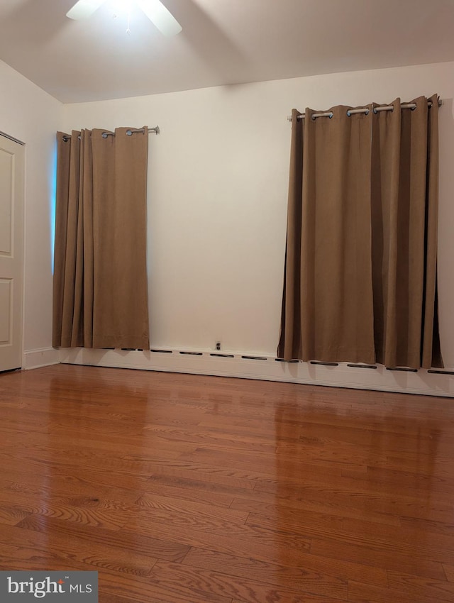 unfurnished room with hardwood / wood-style flooring and ceiling fan