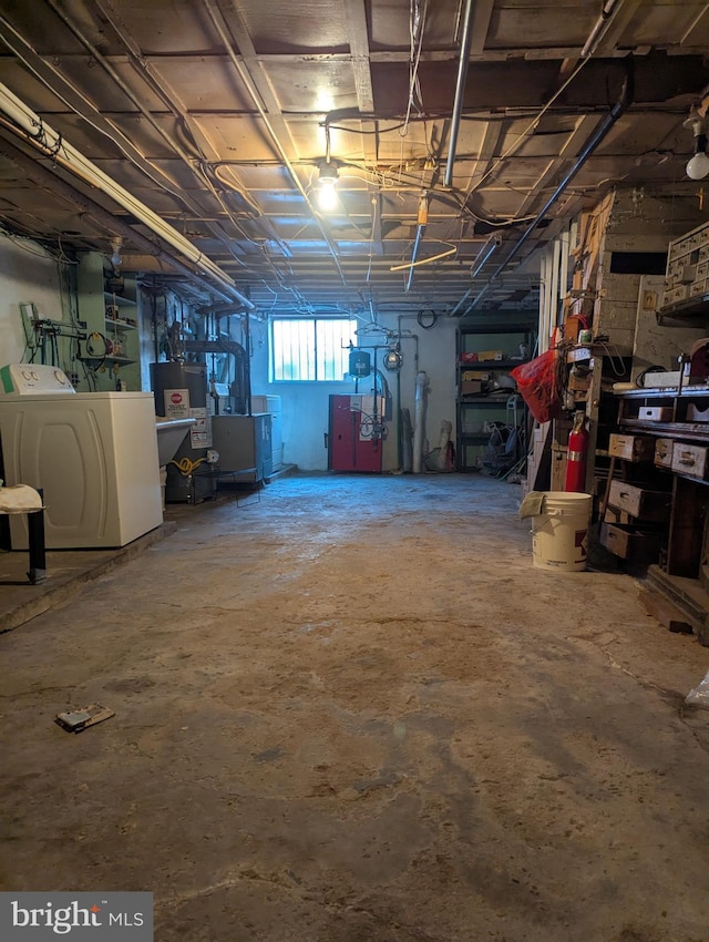 basement with water heater and washer and clothes dryer