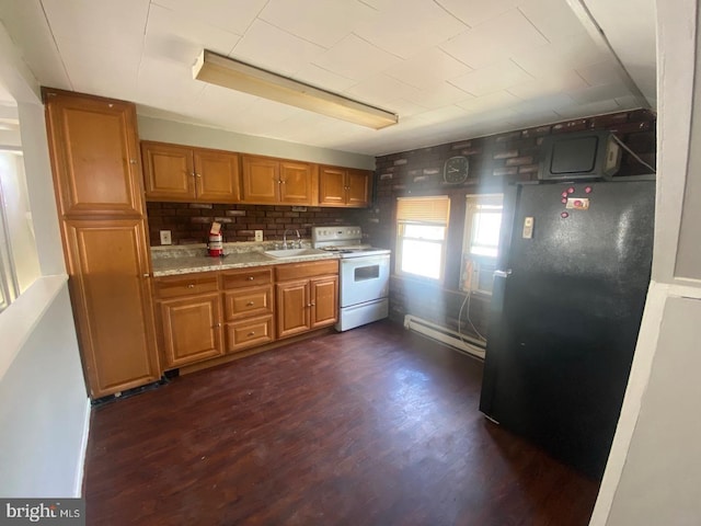 kitchen with dark wood-type flooring, sink, baseboard heating, white range with electric stovetop, and backsplash