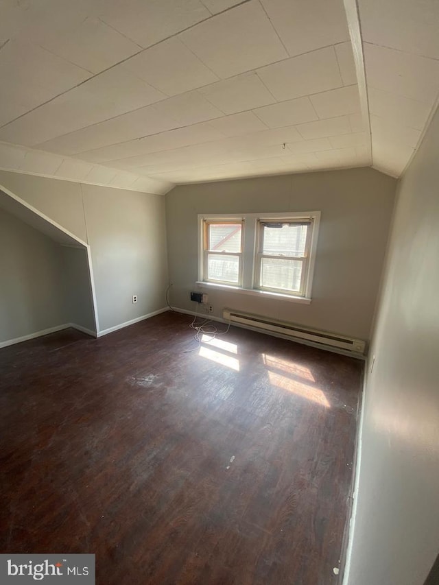 bonus room with baseboard heating, dark wood-type flooring, and vaulted ceiling