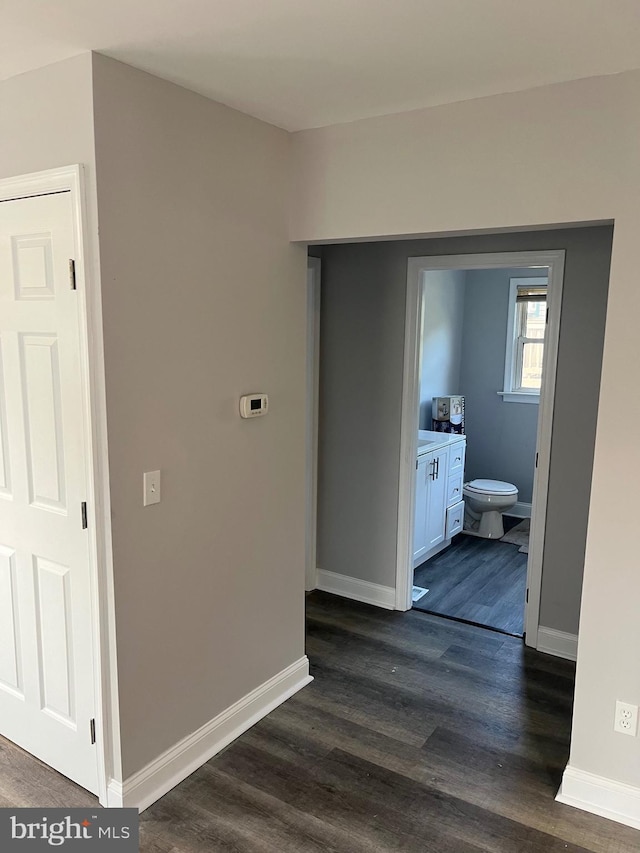 corridor with dark hardwood / wood-style flooring