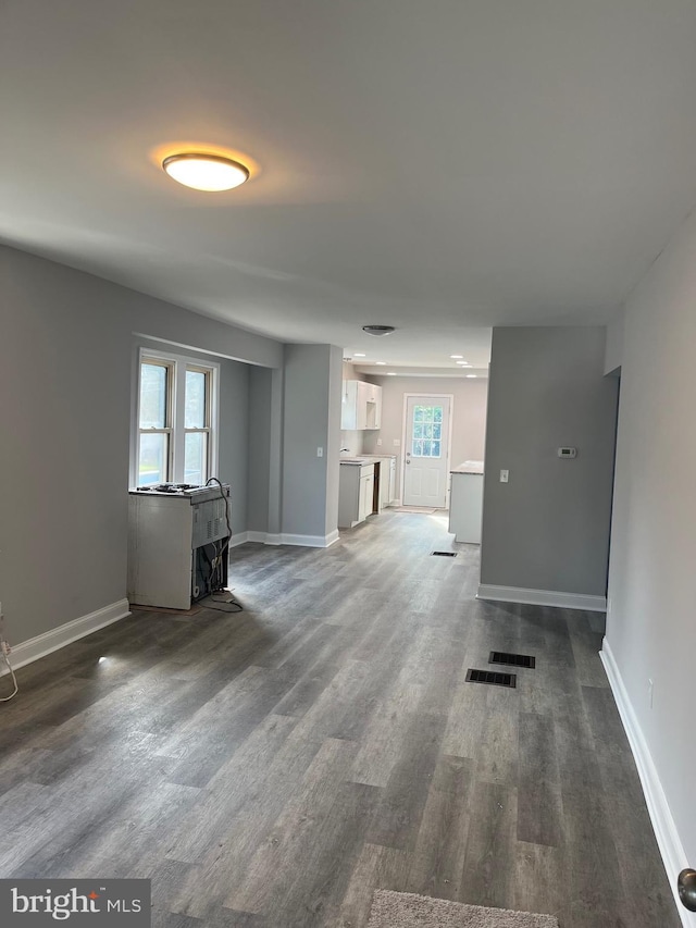 unfurnished living room featuring dark hardwood / wood-style floors