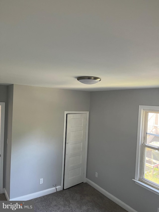 carpeted spare room with a wealth of natural light