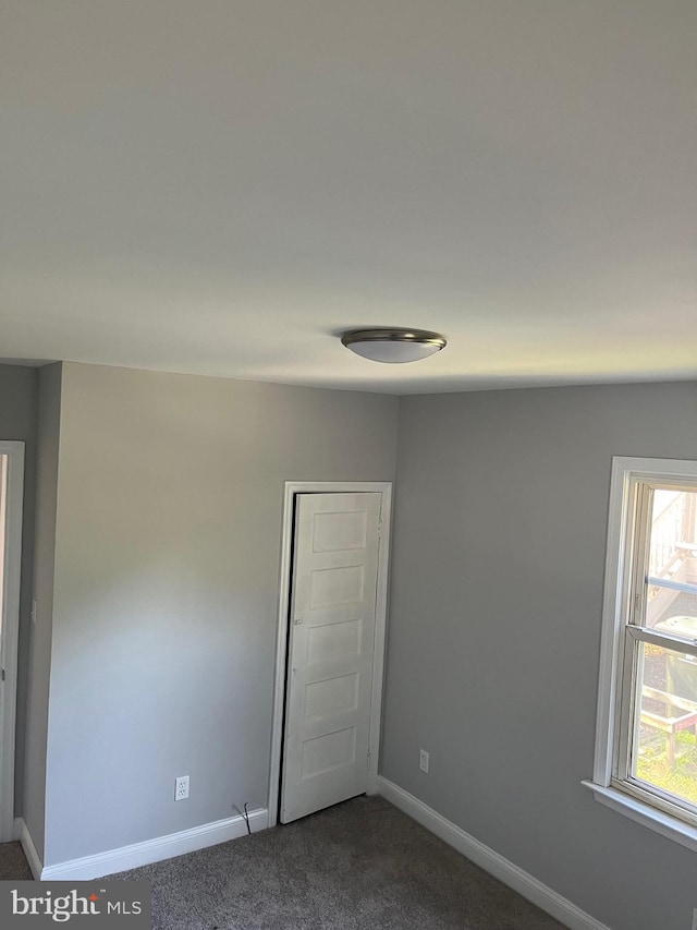 carpeted spare room with a wealth of natural light