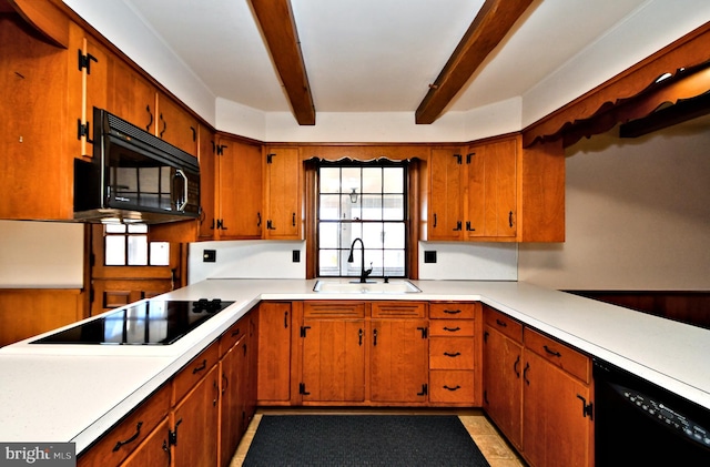 kitchen with beam ceiling, black appliances, light countertops, and a sink