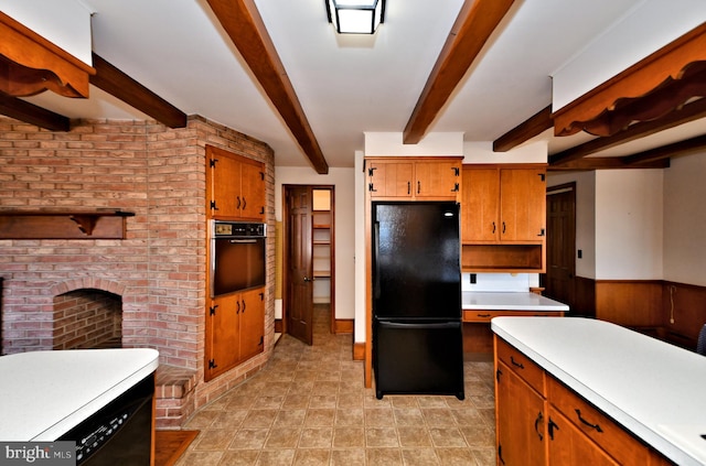 kitchen featuring brown cabinetry, beam ceiling, black appliances, light countertops, and wainscoting