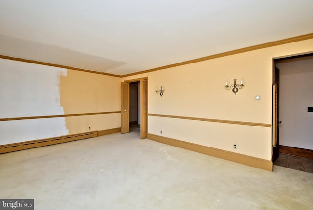 carpeted spare room featuring a baseboard radiator, baseboards, and ornamental molding