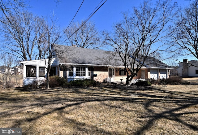 single story home featuring brick siding