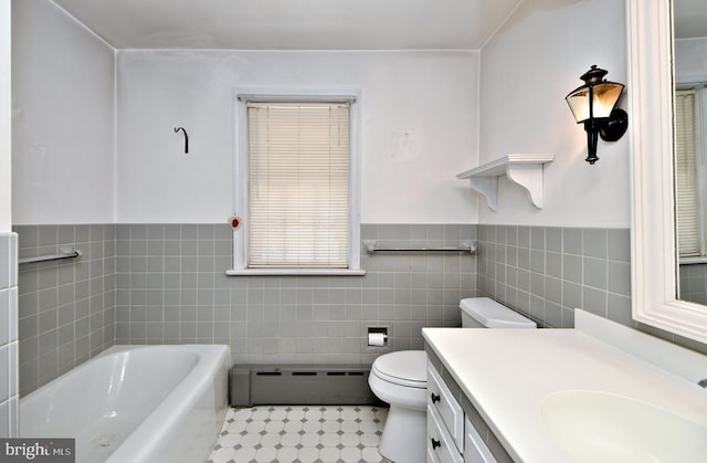 full bath with a washtub, toilet, vanity, tile walls, and a baseboard radiator