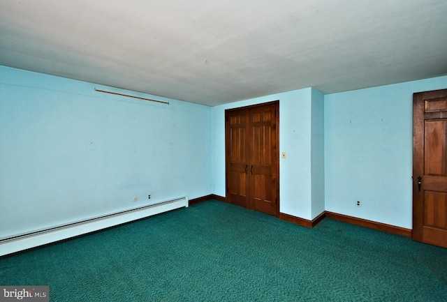 unfurnished bedroom featuring a baseboard heating unit, baseboards, and carpet flooring