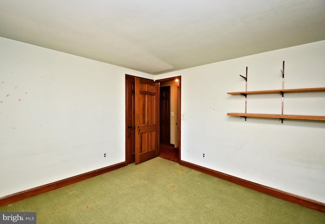 spare room with carpet flooring and baseboards