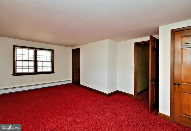 spare room featuring dark colored carpet, a baseboard radiator, and baseboards