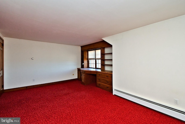 unfurnished room featuring baseboard heating, dark carpet, built in study area, and baseboards