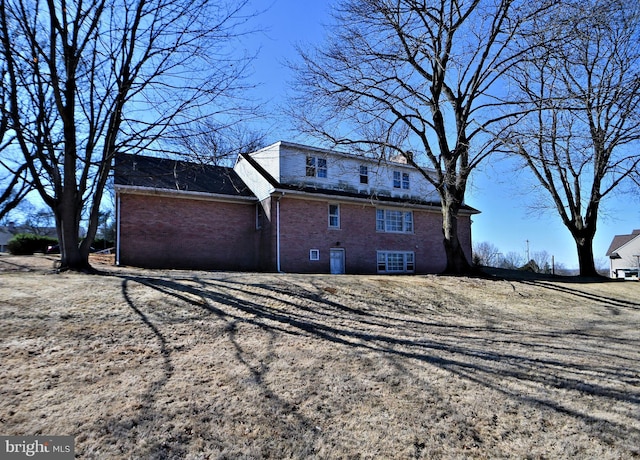 view of property exterior with brick siding