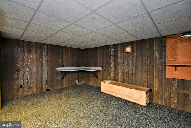 bar featuring wooden walls, carpet, and a drop ceiling