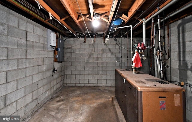 unfinished basement with electric panel and a heating unit