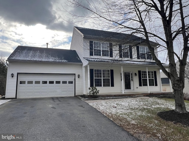 view of front of home with a garage and a porch