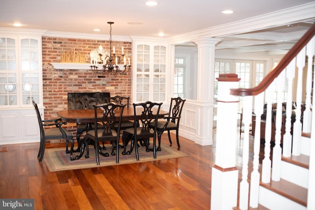 dining space with crown molding, dark hardwood / wood-style floors, beamed ceiling, and ornate columns