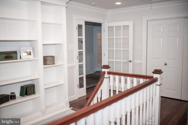 hallway featuring crown molding, dark hardwood / wood-style flooring, and built in features