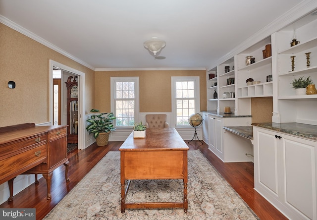 office space with dark hardwood / wood-style flooring, crown molding, and built in desk