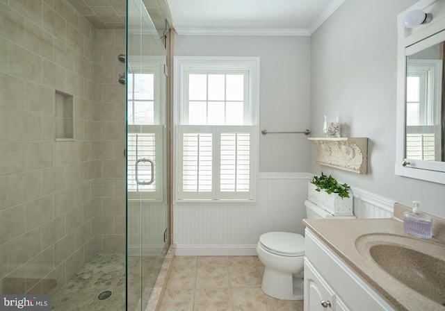 bathroom with a shower with shower door, tile patterned flooring, vanity, ornamental molding, and toilet