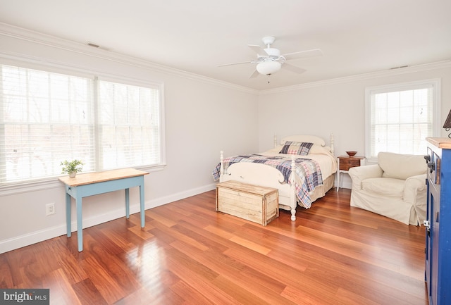 bedroom featuring crown molding, ceiling fan, and wood-type flooring