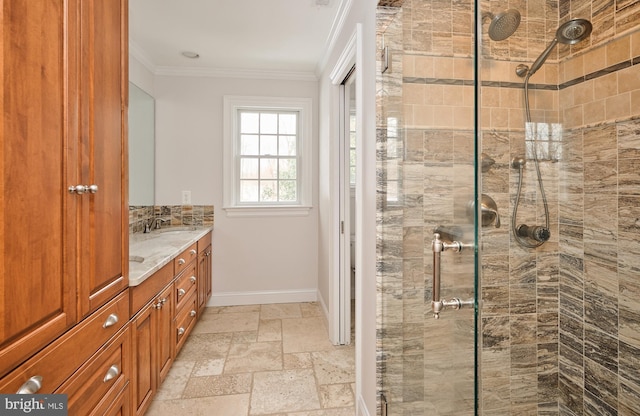 bathroom featuring a shower with door, crown molding, and vanity