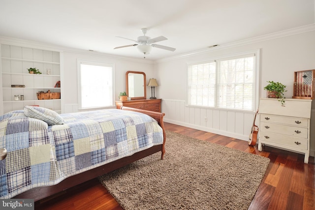 bedroom featuring ceiling fan, ornamental molding, dark hardwood / wood-style floors, and multiple windows