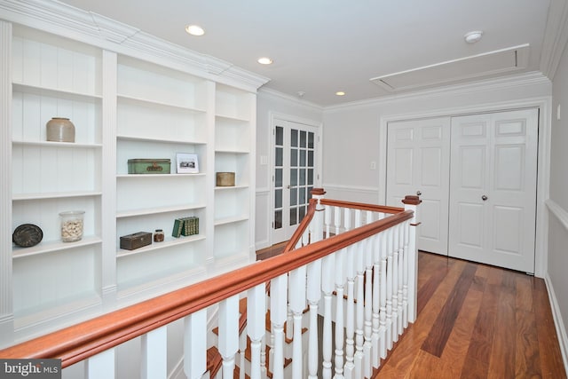 hallway featuring crown molding, dark hardwood / wood-style floors, and built in shelves