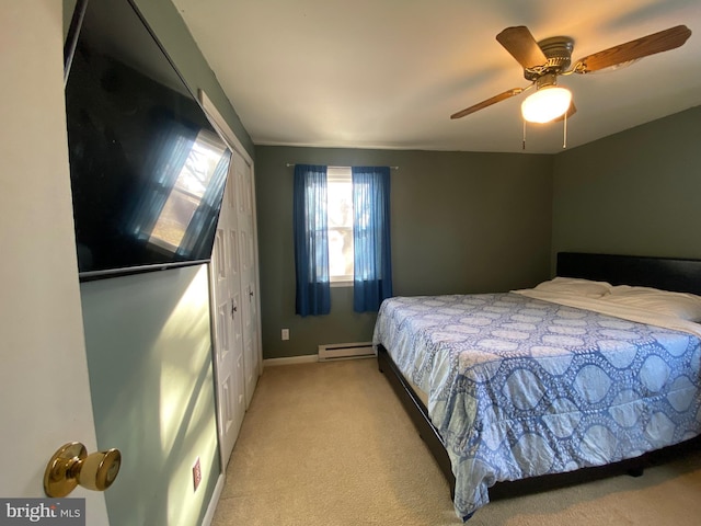 bedroom with ceiling fan, a baseboard radiator, and light carpet