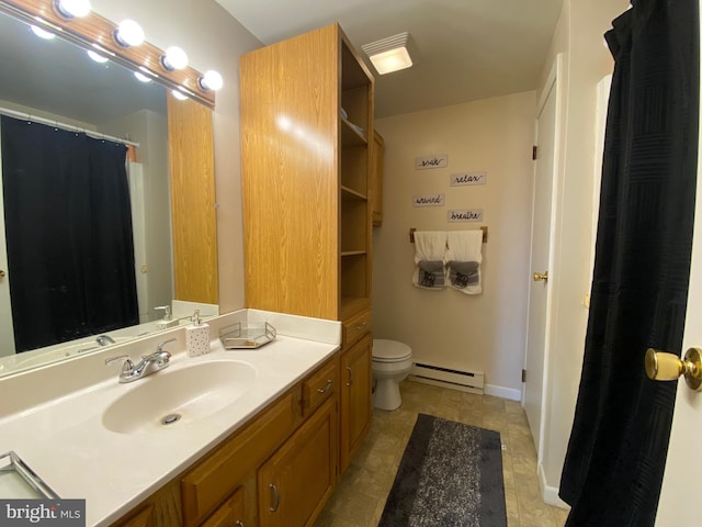 bathroom with vanity, a baseboard heating unit, and toilet