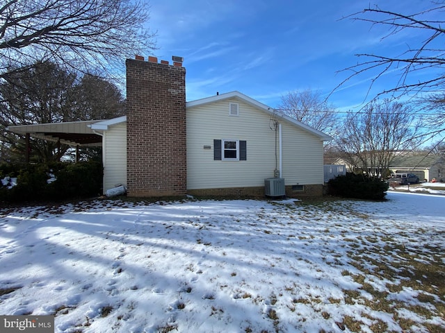 snow covered house with cooling unit