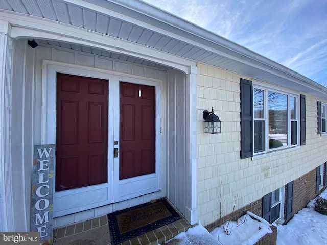 view of snow covered property entrance