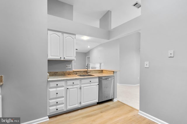 kitchen with white cabinetry, sink, stainless steel dishwasher, and light wood-type flooring