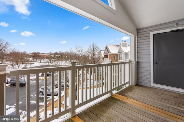 view of snow covered back of property