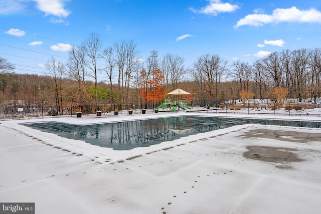 view of swimming pool with a playground