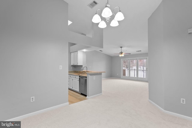 kitchen with dishwasher, sink, white cabinets, hanging light fixtures, and light colored carpet