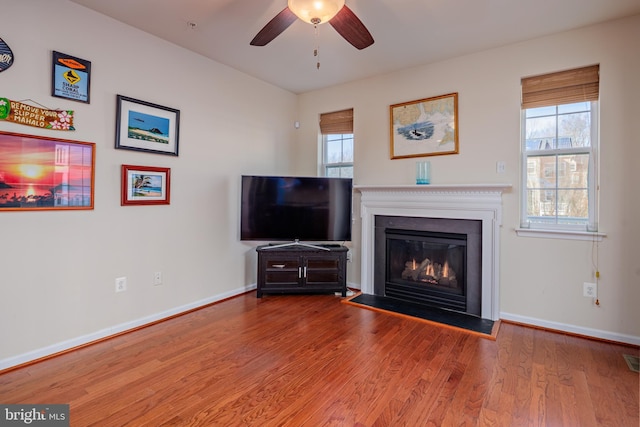 unfurnished living room featuring hardwood / wood-style flooring and ceiling fan