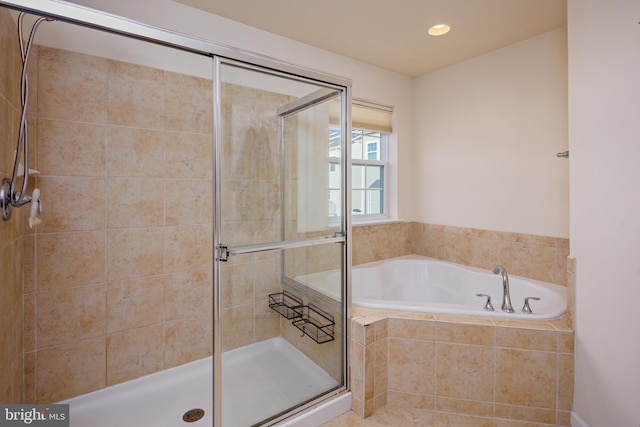 bathroom featuring separate shower and tub