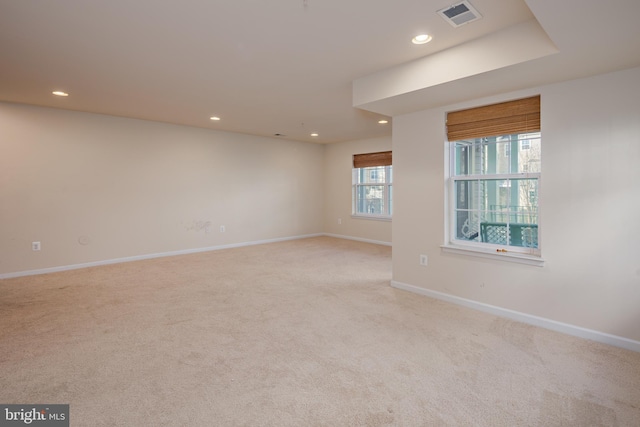 spare room featuring light colored carpet