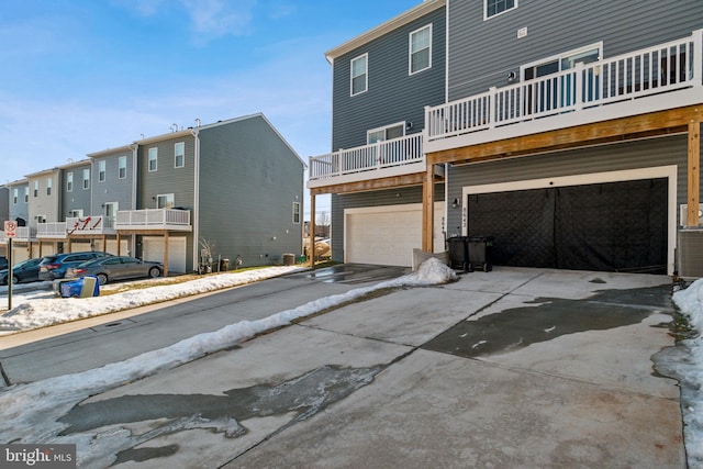 back of property with a garage and a balcony