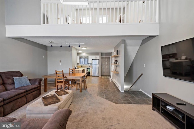 carpeted living room featuring a high ceiling