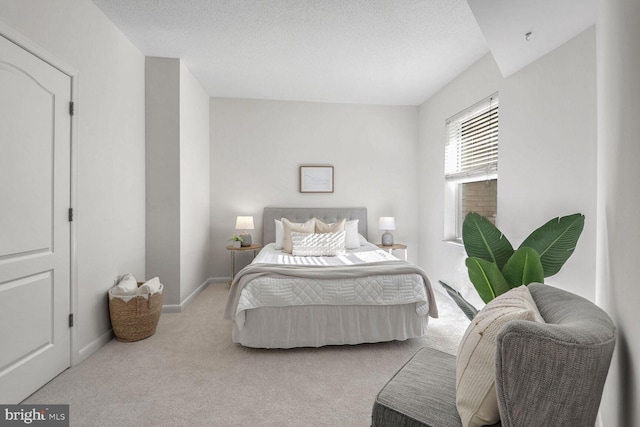 carpeted bedroom with a textured ceiling