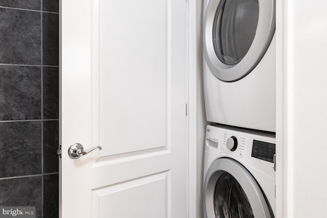 laundry area featuring stacked washer and clothes dryer