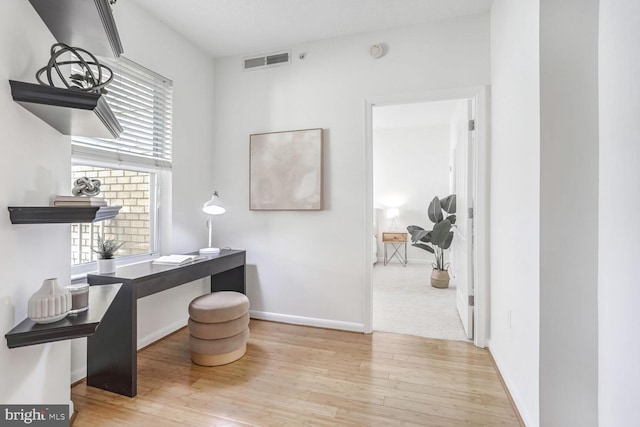 office with light hardwood / wood-style floors