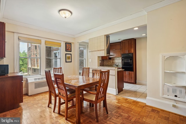 dining room featuring light parquet floors, crown molding, and radiator heating unit