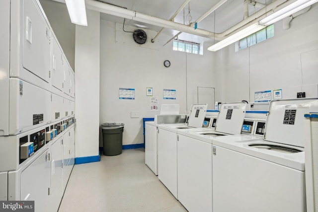 laundry room with independent washer and dryer, stacked washer and clothes dryer, and plenty of natural light